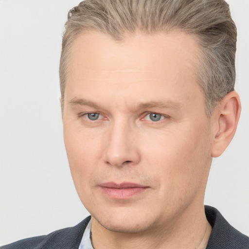 Joyful white adult male with short  brown hair and grey eyes