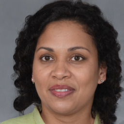 Joyful black adult female with medium  brown hair and brown eyes