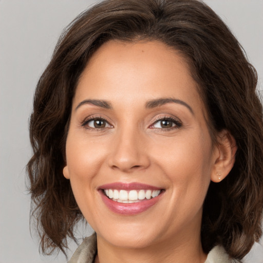 Joyful white young-adult female with medium  brown hair and brown eyes