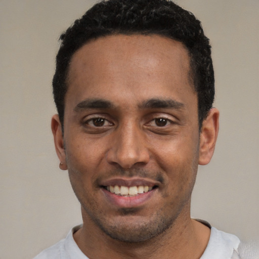 Joyful white young-adult male with short  black hair and brown eyes