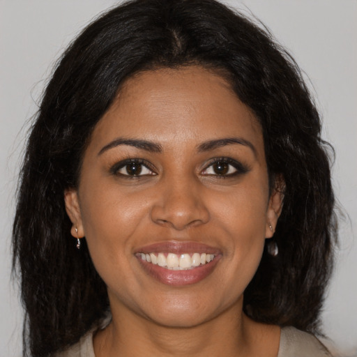 Joyful black young-adult female with medium  brown hair and brown eyes