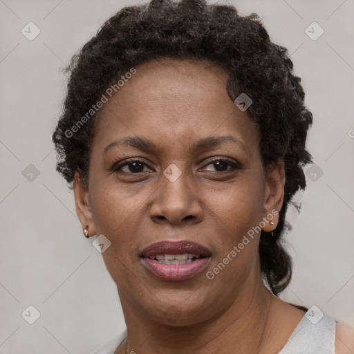 Joyful black adult female with short  brown hair and brown eyes