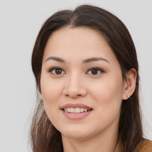 Joyful white young-adult female with long  brown hair and brown eyes