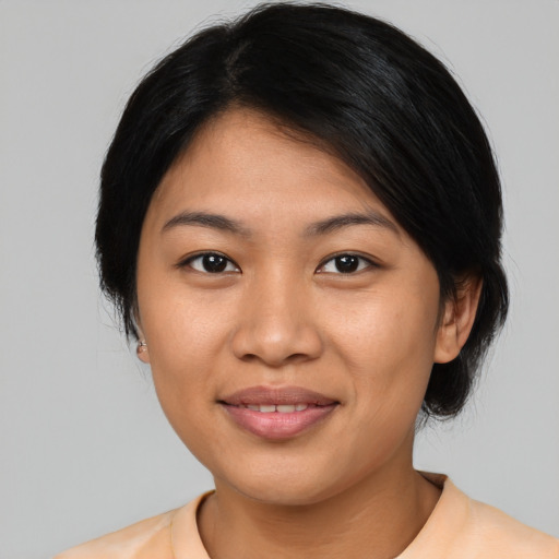 Joyful asian young-adult female with medium  black hair and brown eyes