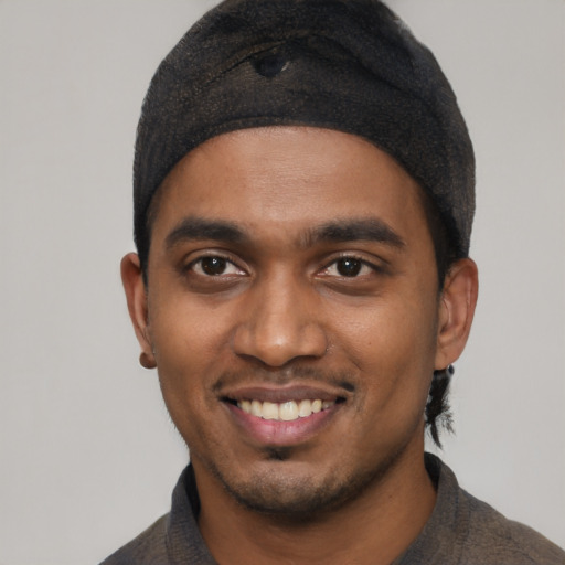 Joyful black young-adult male with short  black hair and brown eyes