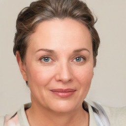 Joyful white adult female with medium  brown hair and grey eyes