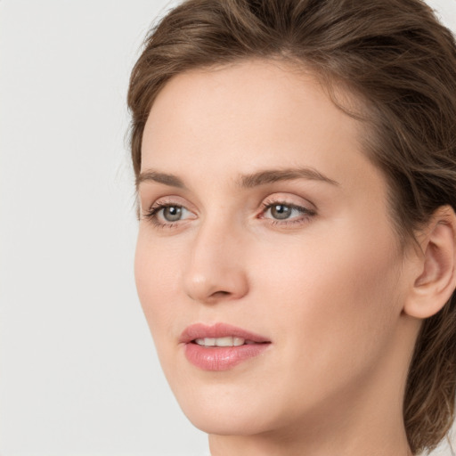 Joyful white young-adult female with medium  brown hair and green eyes