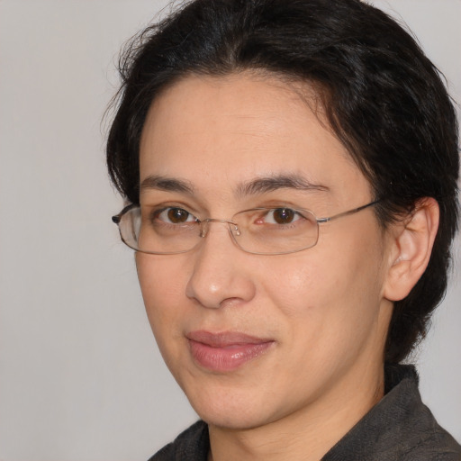 Joyful white adult female with medium  brown hair and brown eyes