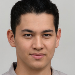 Joyful latino young-adult male with short  brown hair and brown eyes