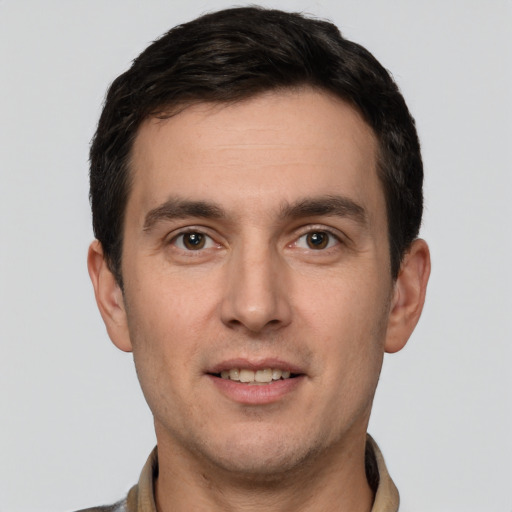 Joyful white young-adult male with short  brown hair and brown eyes