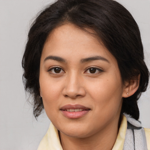 Joyful white young-adult female with medium  brown hair and brown eyes