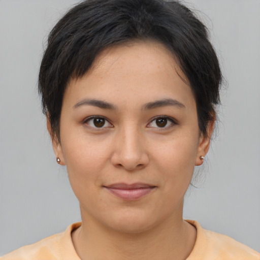 Joyful asian young-adult female with short  brown hair and brown eyes