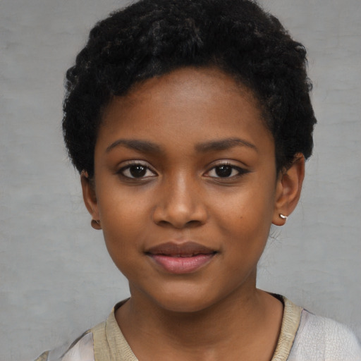 Joyful black child female with short  black hair and brown eyes