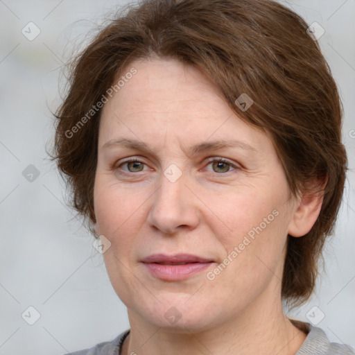 Joyful white adult female with medium  brown hair and grey eyes