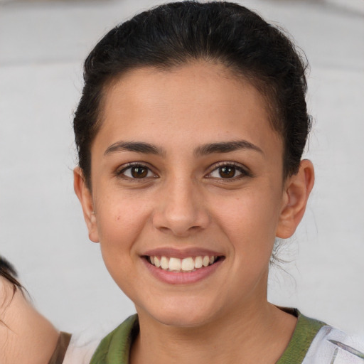 Joyful white young-adult female with short  brown hair and brown eyes