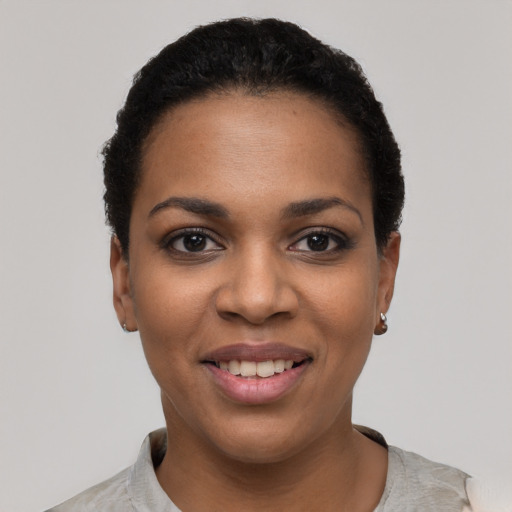 Joyful latino young-adult female with short  black hair and brown eyes