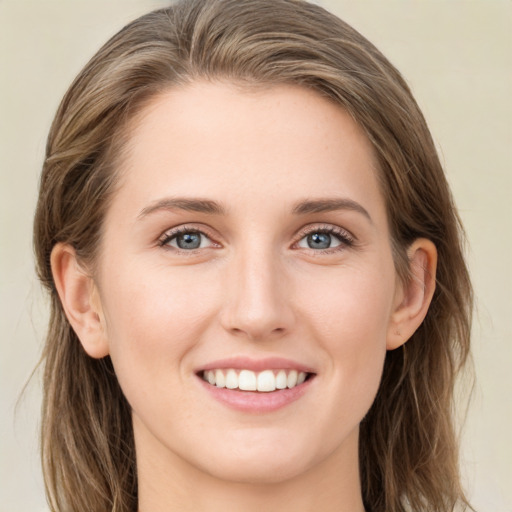 Joyful white young-adult female with long  brown hair and green eyes