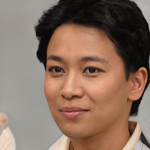 Joyful asian young-adult female with short  brown hair and brown eyes