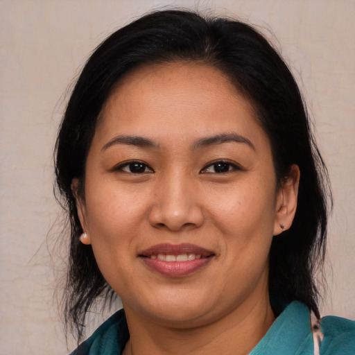 Joyful asian young-adult female with medium  brown hair and brown eyes