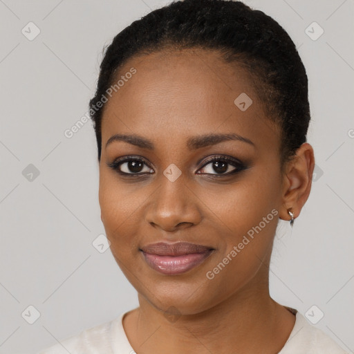 Joyful black young-adult female with short  black hair and brown eyes