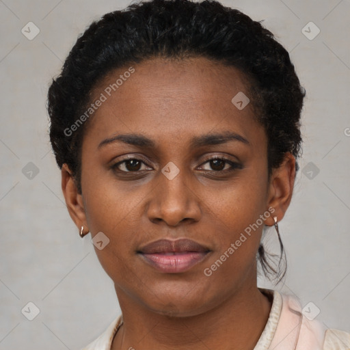 Joyful black young-adult female with short  black hair and brown eyes