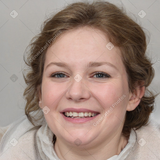 Joyful white young-adult female with medium  brown hair and blue eyes