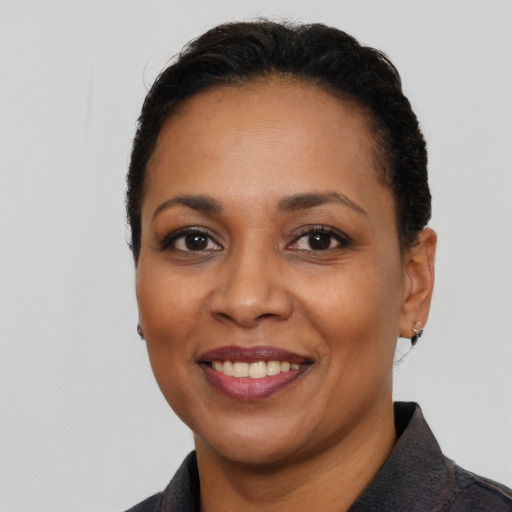Joyful latino adult female with short  black hair and brown eyes
