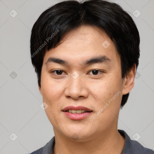 Joyful asian young-adult male with short  black hair and brown eyes