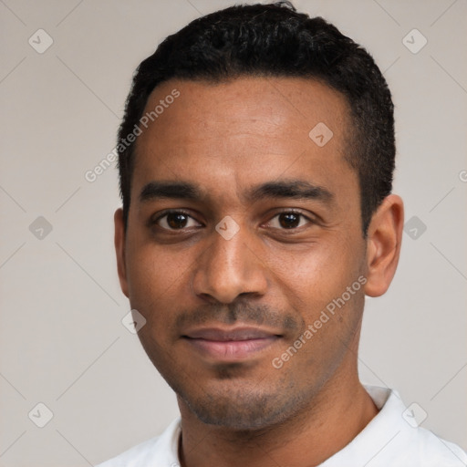 Joyful black young-adult male with short  black hair and brown eyes