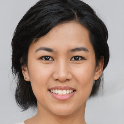 Joyful asian young-adult female with medium  black hair and brown eyes