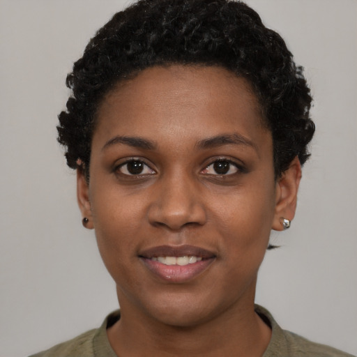 Joyful black young-adult female with short  black hair and brown eyes