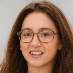 Joyful white adult female with long  brown hair and brown eyes