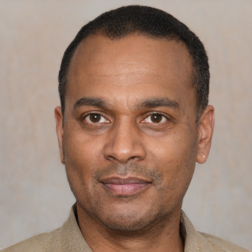 Joyful latino adult male with short  black hair and brown eyes