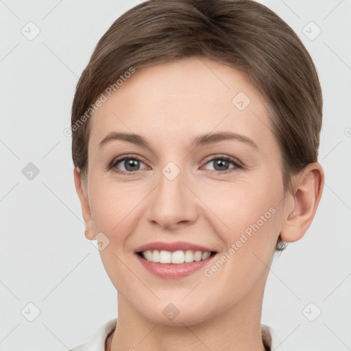 Joyful white young-adult female with short  brown hair and grey eyes