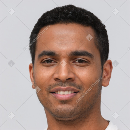 Joyful latino young-adult male with short  black hair and brown eyes