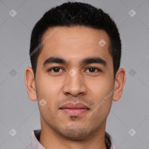 Joyful latino young-adult male with short  black hair and brown eyes