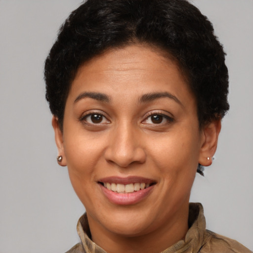 Joyful latino young-adult female with short  brown hair and brown eyes