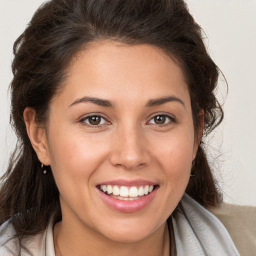 Joyful white young-adult female with long  brown hair and brown eyes