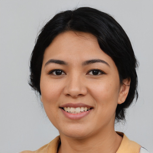Joyful asian young-adult female with medium  black hair and brown eyes