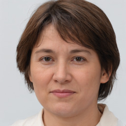 Joyful white adult female with medium  brown hair and brown eyes