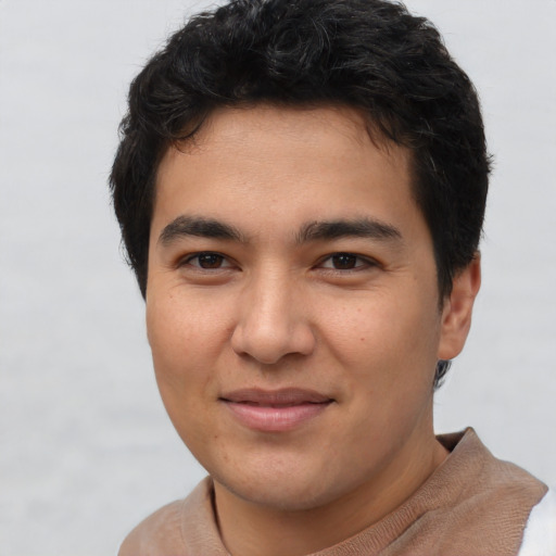 Joyful latino young-adult male with short  brown hair and brown eyes