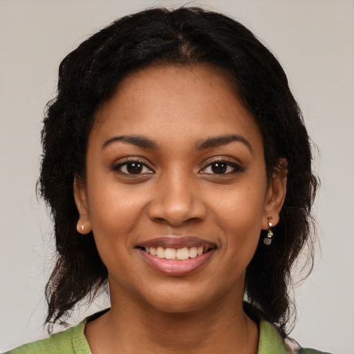 Joyful black young-adult female with medium  black hair and brown eyes