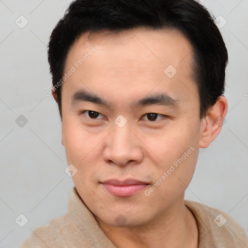 Joyful asian young-adult male with short  brown hair and brown eyes