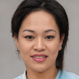 Joyful asian young-adult female with medium  brown hair and brown eyes