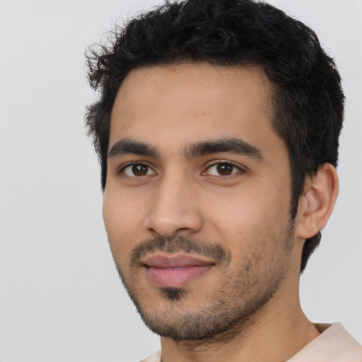 Joyful latino young-adult male with short  black hair and brown eyes