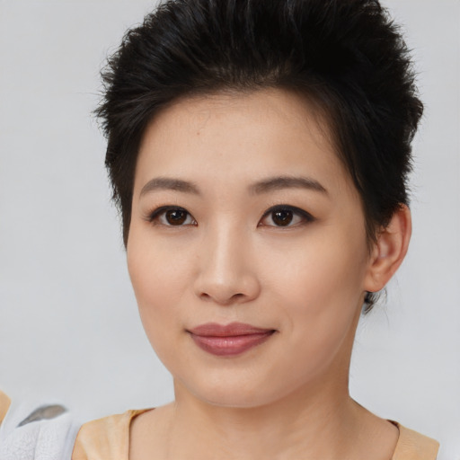 Joyful asian young-adult female with short  brown hair and brown eyes