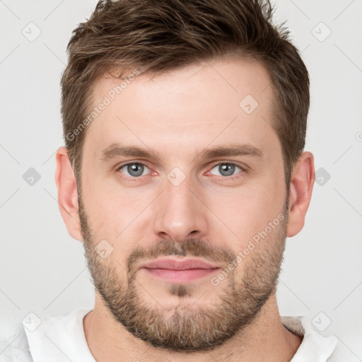 Joyful white young-adult male with short  brown hair and grey eyes