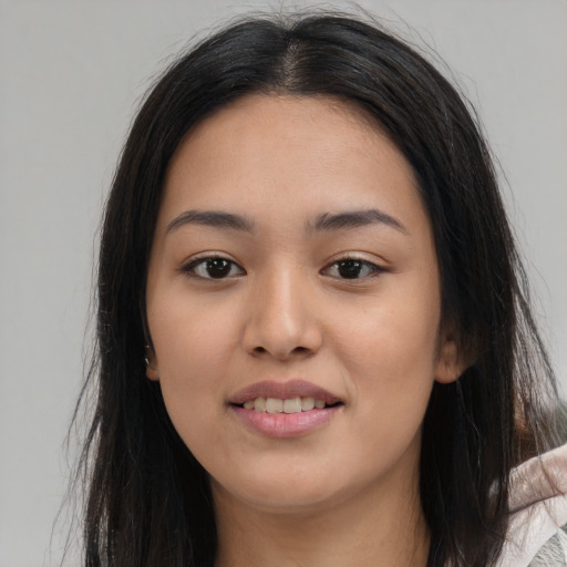 Joyful asian young-adult female with long  brown hair and brown eyes