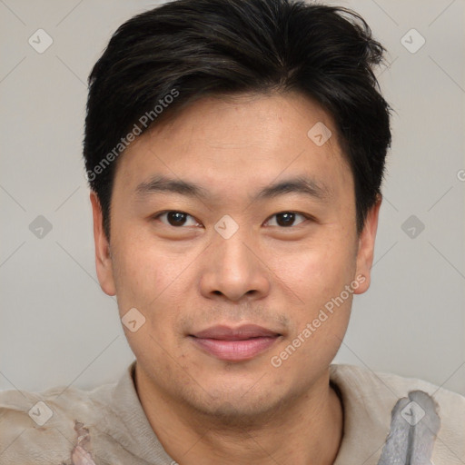 Joyful asian young-adult male with short  brown hair and brown eyes