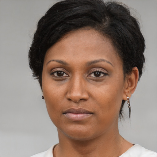 Neutral black adult female with medium  brown hair and brown eyes